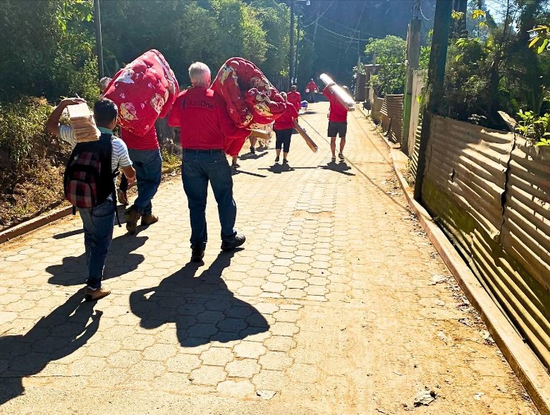 Carrying beds up the village road
