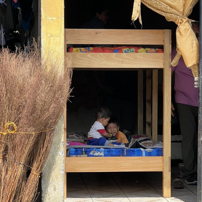 Two children in their new bunk bed